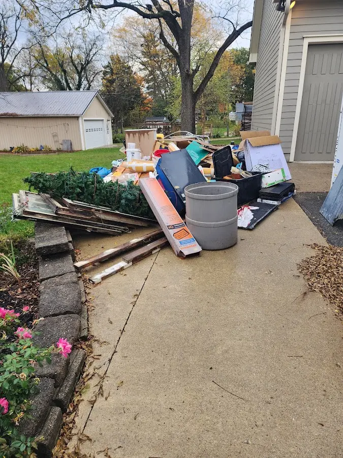 Dumpster being loaded with debris for Estate Cleanout Dumpster Rental in Bayport